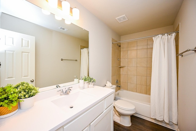 10130 Barn Owl Trl, Magnolia, TX 77354 - bathroom with wood finished floors, toilet, vanity, and shower / bath combo with shower curtain