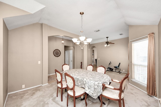 11843 Leaf Oak Dr, Houston, TX 77065 - dining room featuring arched walkways, lofted ceiling, light colored carpet, ceiling fan, and baseboards