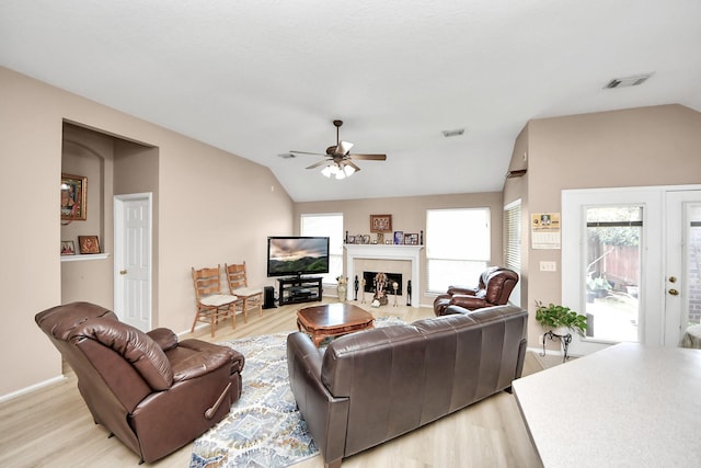 11843 Leaf Oak Dr, Houston, TX 77065 - living room featuring lofted ceiling, light wood-type flooring, a ceiling fan, a fireplace with flush hearth, and baseboards