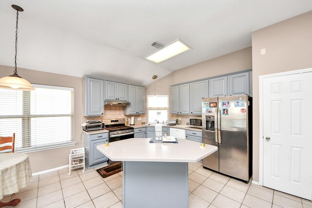 11843 Leaf Oak Dr, Houston, TX 77065 - kitchen with stainless steel appliances, gray cabinets, vaulted ceiling, healthy amount of natural light, and light countertops