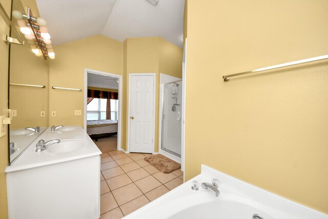 11843 Leaf Oak Dr, Houston, TX 77065 - ensuite bathroom with vaulted ceiling, tile patterned flooring, a shower stall, a bath, and double vanity
