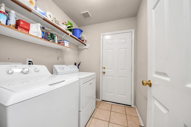 11843 Leaf Oak Dr, Houston, TX 77065 - clothes washing area with separate washer and dryer, light tile patterned floors, and baseboards