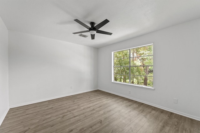 563 Roanoke Dr, Conroe, TX 77302 - empty room featuring wood finished floors, baseboards, and a ceiling fan