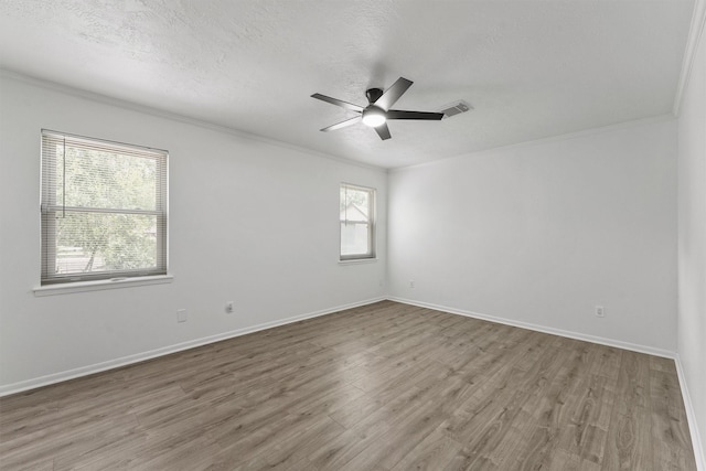 563 Roanoke Dr, Conroe, TX 77302 - unfurnished room with wood finished floors, ceiling fan, crown molding, baseboards, and a textured ceiling