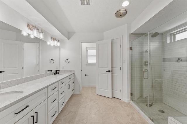 563 Roanoke Dr, Conroe, TX 77302 - full bathroom with a stall shower, double vanity, and baseboards