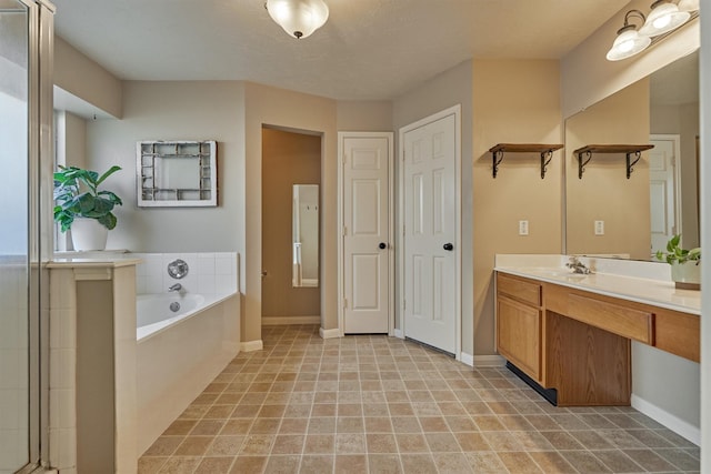full bathroom featuring a bath, baseboards, and vanity