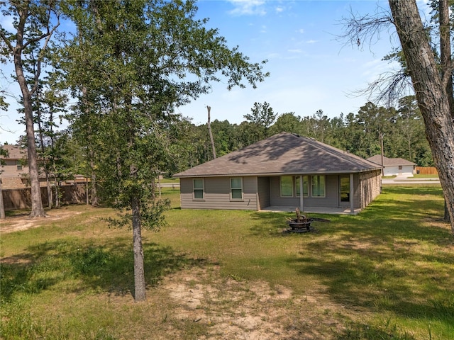 back of house with a fire pit and a patio area