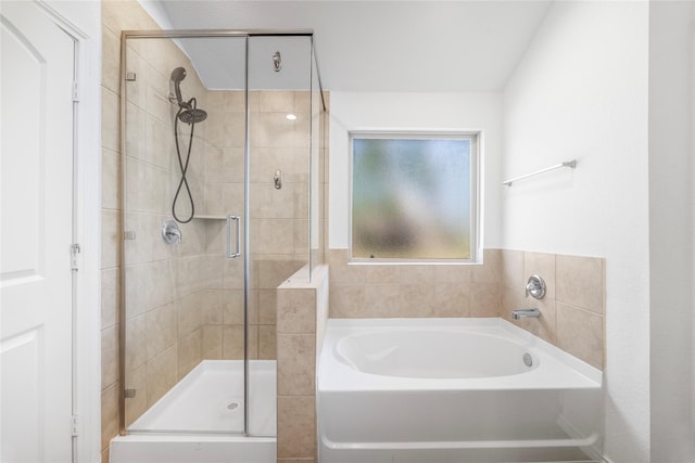 bathroom featuring a stall shower and a garden tub