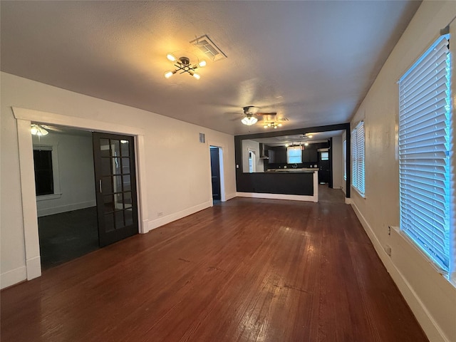 544 W 28th St, Houston, TX 77008 - unfurnished living room with ceiling fan, dark wood-style flooring, and baseboards