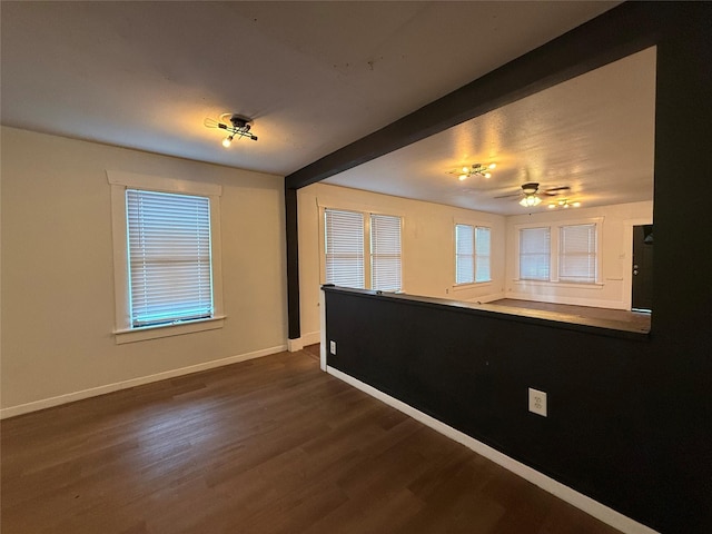 544 W 28th St, Houston, TX 77008 - unfurnished room with baseboards, dark wood-style floors, beam ceiling, and ceiling fan