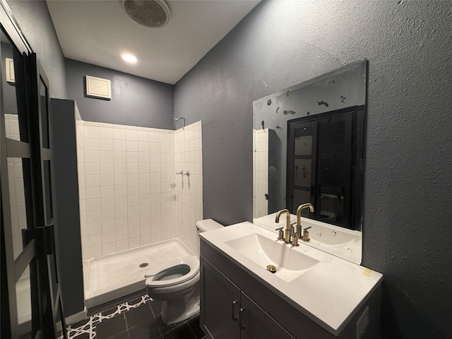 544 W 28th St, Houston, TX 77008 - full bath with a textured wall, toilet, a shower stall, tile patterned floors, and vanity