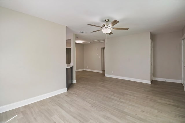 1306 W 6th St, Freeport, TX 77541 - unfurnished living room featuring ceiling fan, light wood-type flooring, and baseboards