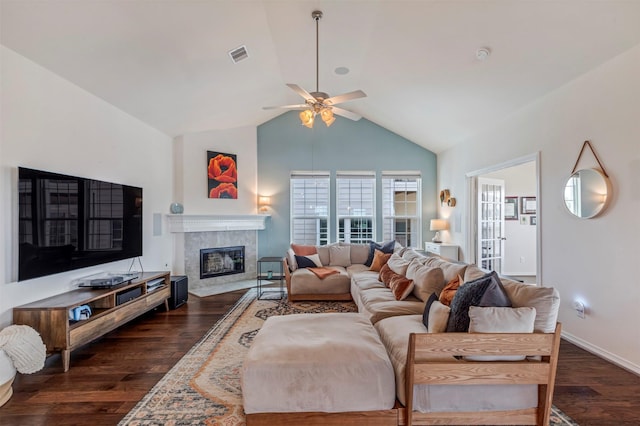 2101 Menard Ave, Seabrook, TX 77586 - living area with dark wood finished floors, ceiling fan, vaulted ceiling, a premium fireplace, and baseboards