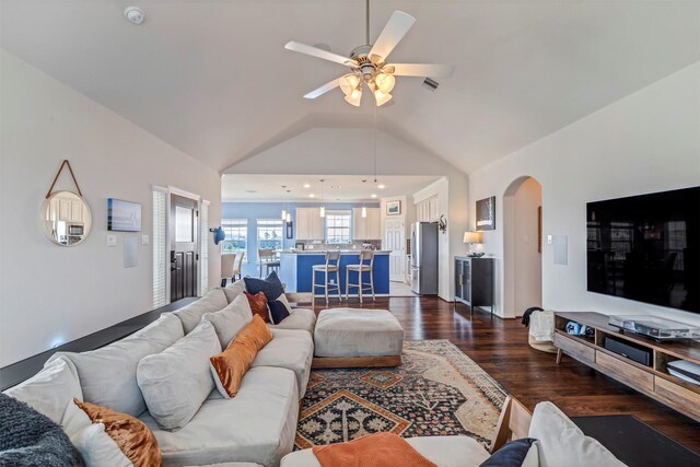 2101 Menard Ave, Seabrook, TX 77586 - living area featuring lofted ceiling, arched walkways, dark wood-style flooring, and a ceiling fan