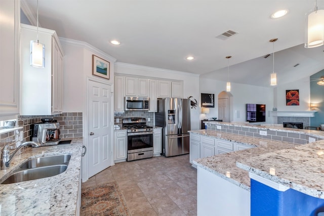 2101 Menard Ave, Seabrook, TX 77586 - kitchen featuring stainless steel appliances, a sink, tasteful backsplash, arched walkways, and light stone countertops