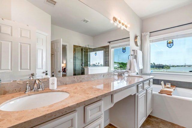 2101 Menard Ave, Seabrook, TX 77586 - full bathroom featuring a shower stall, double vanity, a tub to relax in, and tile patterned floors