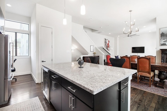 2205 Colorado St, Houston, TX 77007 - kitchen featuring dark cabinetry, freestanding refrigerator, dark wood-style flooring, wine cooler, and a chandelier
