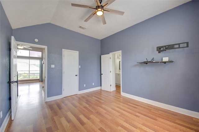unfurnished bedroom featuring light wood-style floors, high vaulted ceiling, baseboards, and a ceiling fan