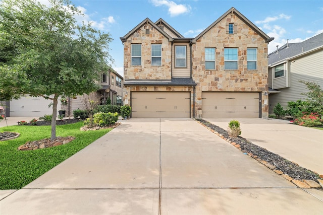 29122 Artic Brook Ln, Fulshear, TX 77441 - view of front of home featuring stone siding, driveway, and a garage