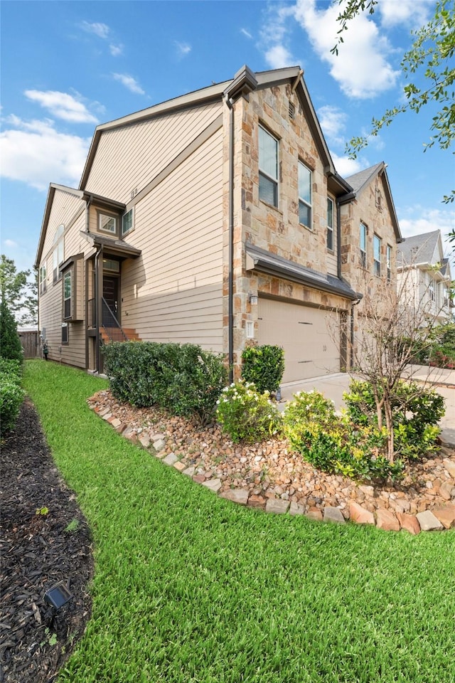 29122 Artic Brook Ln, Fulshear, TX 77441 - view of side of property with a garage, stone siding, driveway, and a yard