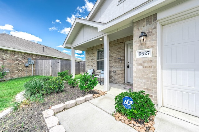 9927 Archdale Spring Dr, Baytown, TX 77521 - entrance to property with a porch, brick siding, and fence