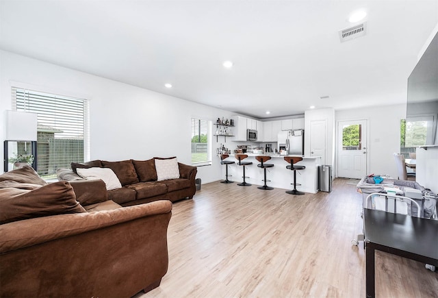 9927 Archdale Spring Dr, Baytown, TX 77521 - living area with light wood finished floors and recessed lighting