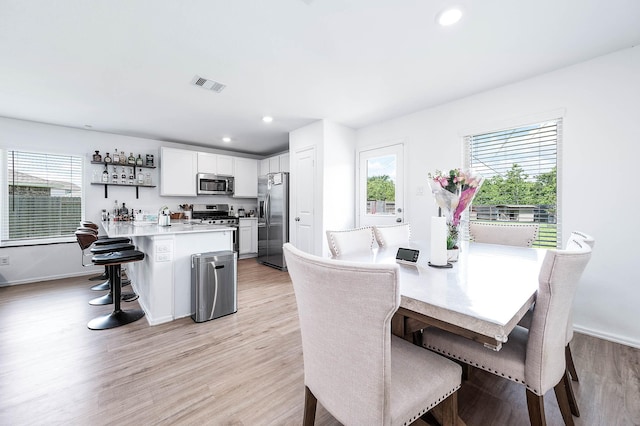 9927 Archdale Spring Dr, Baytown, TX 77521 - dining space with light wood-style flooring, recessed lighting, and baseboards
