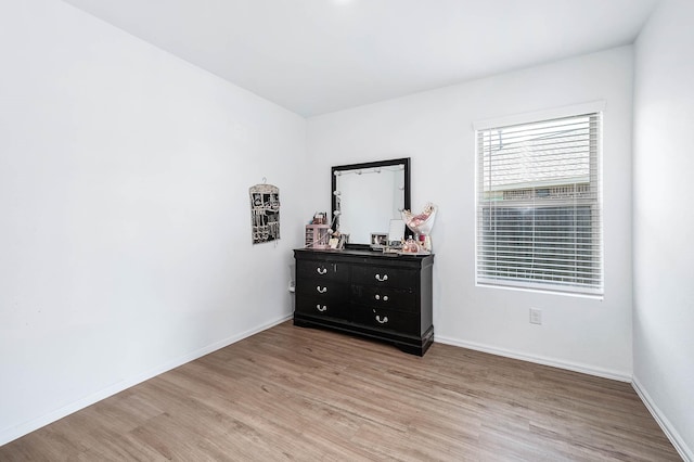 9927 Archdale Spring Dr, Baytown, TX 77521 - bedroom with light wood-style floors and baseboards