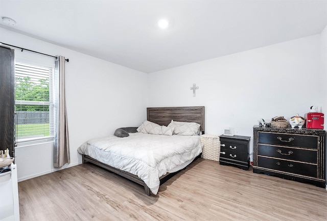 9927 Archdale Spring Dr, Baytown, TX 77521 - bedroom with light wood-style flooring and baseboards