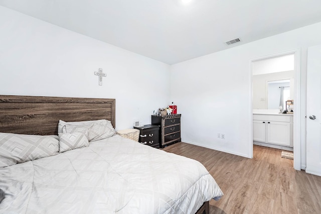 9927 Archdale Spring Dr, Baytown, TX 77521 - bedroom featuring light wood-type flooring, baseboards, and ensuite bathroom