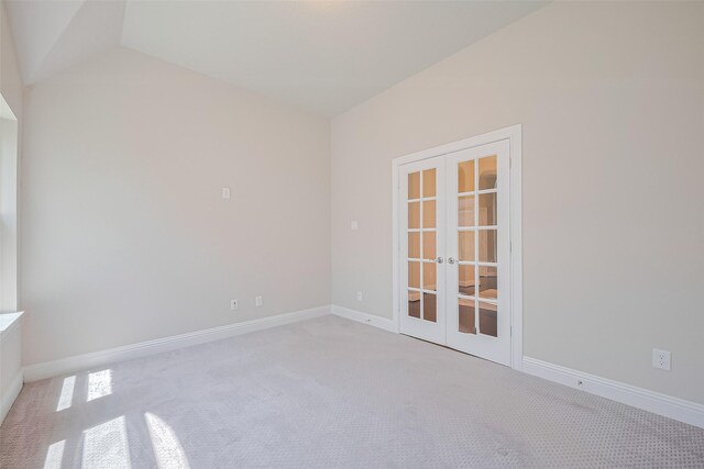 empty room featuring french doors, carpet, and baseboards