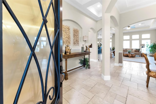 222 Reynosa Ct, Pinehurst, TX 77362 - foyer featuring a ceiling fan, arched walkways, crown molding, stone tile flooring, and recessed lighting