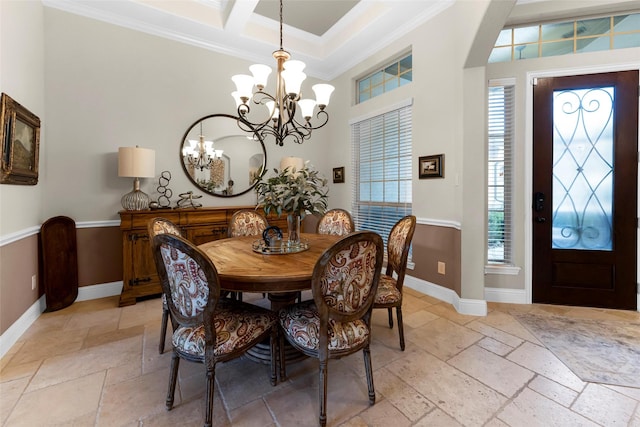 222 Reynosa Ct, Pinehurst, TX 77362 - dining space with stone tile floors, crown molding, a chandelier, baseboards, and healthy amount of natural light