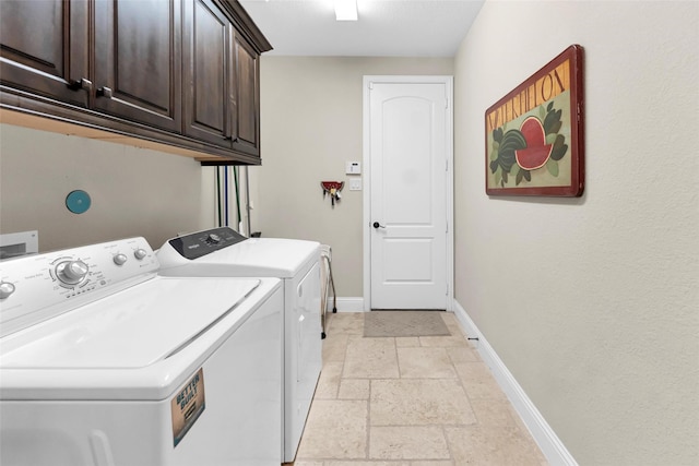 222 Reynosa Ct, Pinehurst, TX 77362 - laundry room with cabinet space, independent washer and dryer, stone tile flooring, and baseboards