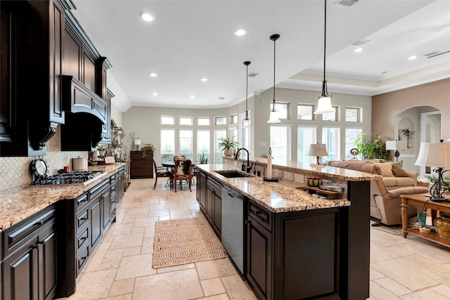 222 Reynosa Ct, Pinehurst, TX 77362 - kitchen featuring stone tile flooring, appliances with stainless steel finishes, a sink, open floor plan, and recessed lighting