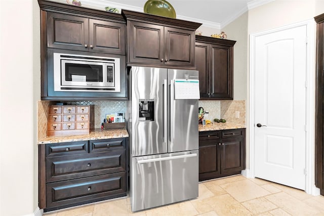 222 Reynosa Ct, Pinehurst, TX 77362 - kitchen featuring stainless steel appliances, decorative backsplash, dark brown cabinets, crown molding, and light stone countertops
