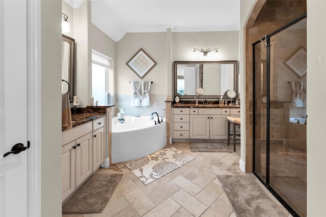 222 Reynosa Ct, Pinehurst, TX 77362 - bathroom featuring ornamental molding, a shower stall, a bath, two vanities, and stone tile flooring