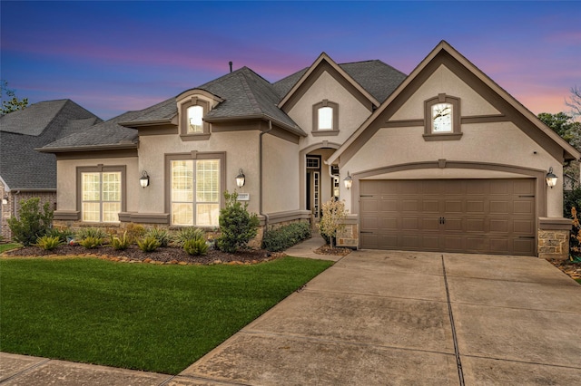 222 Reynosa Ct, Pinehurst, TX 77362 - french provincial home featuring stucco siding, concrete driveway, a yard, a garage, and roof with shingles