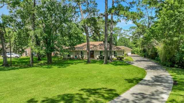 6206 Bayou Blvd, Baytown, TX 77521 - view of front facade with a front yard and a shingled roof