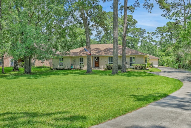 6206 Bayou Blvd, Baytown, TX 77521 - ranch-style home with a front lawn and driveway