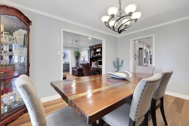 6206 Bayou Blvd, Baytown, TX 77521 - dining area with a chandelier, wood finished floors, baseboards, and crown molding