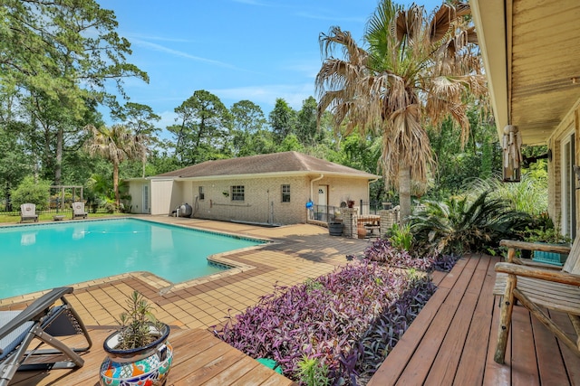 6206 Bayou Blvd, Baytown, TX 77521 - view of pool with a wooden deck and view of scattered trees