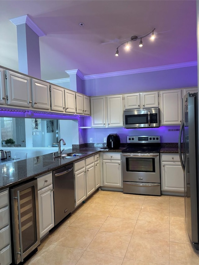 2111 Welch St Unit A307, Houston, TX 77019 - kitchen with appliances with stainless steel finishes, wine cooler, a sink, ornamental molding, and light tile patterned flooring