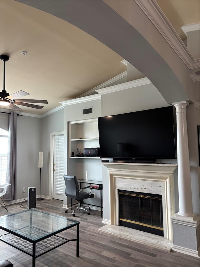 2111 Welch St Unit A307, Houston, TX 77019 - living room with ornate columns, ceiling fan, crown molding, wood finished floors, and a premium fireplace