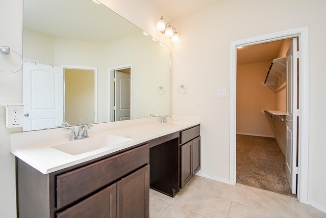 4622 Stolz Trl, Katy, TX 77493 - bathroom featuring double vanity, tile patterned floors, baseboards, and a spacious closet