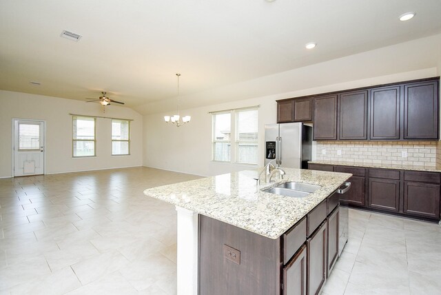 4622 Stolz Trl, Katy, TX 77493 - kitchen featuring stainless steel refrigerator with ice dispenser, a sink, decorative backsplash, a ceiling fan, and a kitchen island with sink