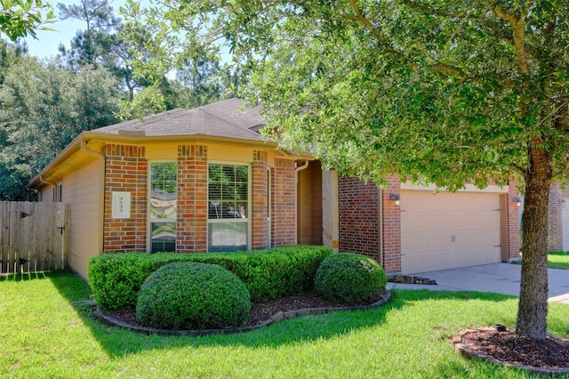 9533 E Woodmark, Conroe, TX 77304 - view of front of home featuring brick siding, an attached garage, and driveway