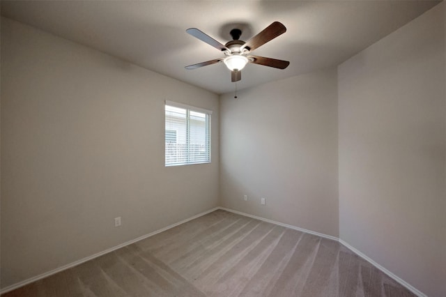 9533 E Woodmark, Conroe, TX 77304 - spare room featuring a ceiling fan, baseboards, and light carpet
