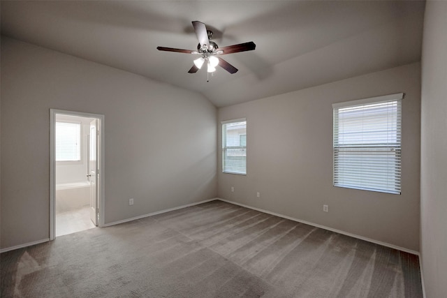 9533 E Woodmark, Conroe, TX 77304 - carpeted spare room featuring a ceiling fan, baseboards, and vaulted ceiling