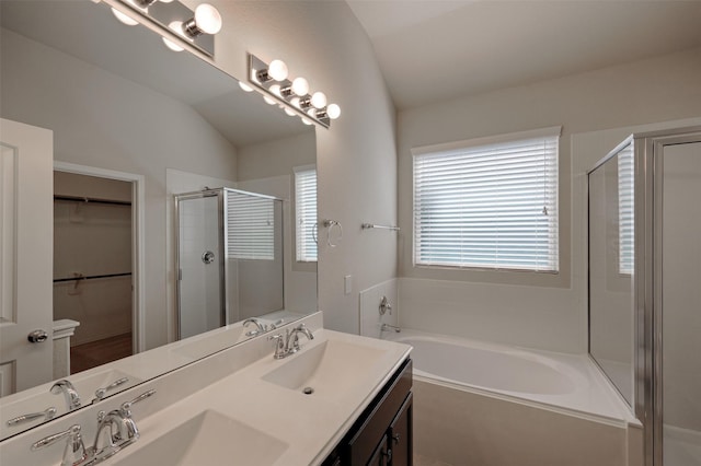9533 E Woodmark, Conroe, TX 77304 - bathroom featuring a shower stall, a garden tub, a walk in closet, double vanity, and lofted ceiling